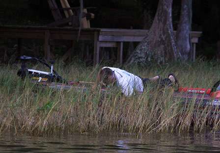 Paul Reutlinger keeps his line tight and makes his way into the grass to retrieve the bass, but the fish was gone.