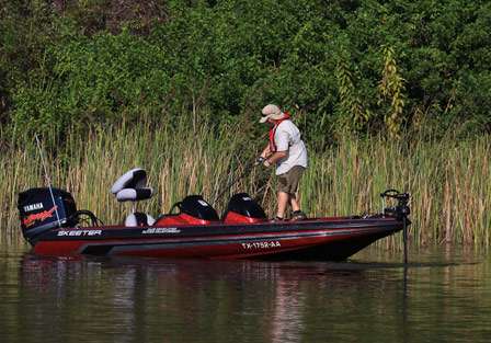 Don Hogue fights a bass to the boat, being extra careful not to force the fish in, risking breaking his line.