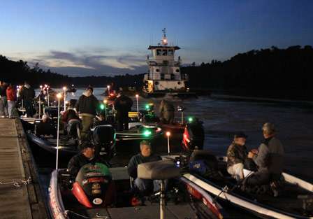 Bassmaster anglers watch as a barge captain navigates his tug within feet of more than 100 bass boats, knowing with the weight of the barge, and ripping current, there would be no way to stop if it got out of control.