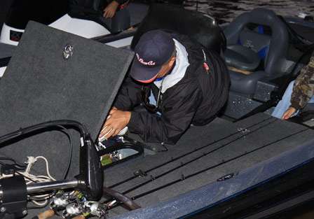 David Gillham almost disappears into his bait box as he makes last-minute adjustments to his gear.