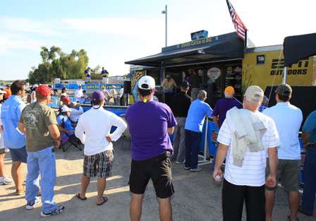 Anglers gather with fans in front of the stage to see if the weights change from the later flights of anglers. 
