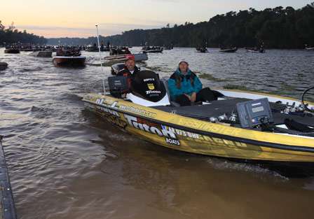 Bassmaster Elite Series pro Jimmy Mize idles through the inspection line as other competitors fall into position behind him.