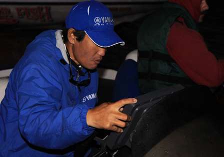 Bassmaster Elite Series pro Takahiro Omori takes one last look at the map on his electronics before launch.