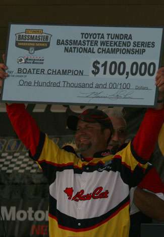 Darrell West holds up the check for 100,000 dollars that he will cash for winning the Toyota Tundra Bassmaster Weekend Series Championship.