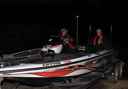 Bassmaster Elite pro Edwin Evers looks back at his engine as he lowers it for launch. Due to the length of run time to get to their respective fishing spots, this 