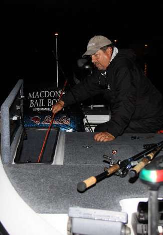 Joe Clements puts away rods that were splayed across the deck of his boat, possibly an indication of how far he would be running on Day Two.