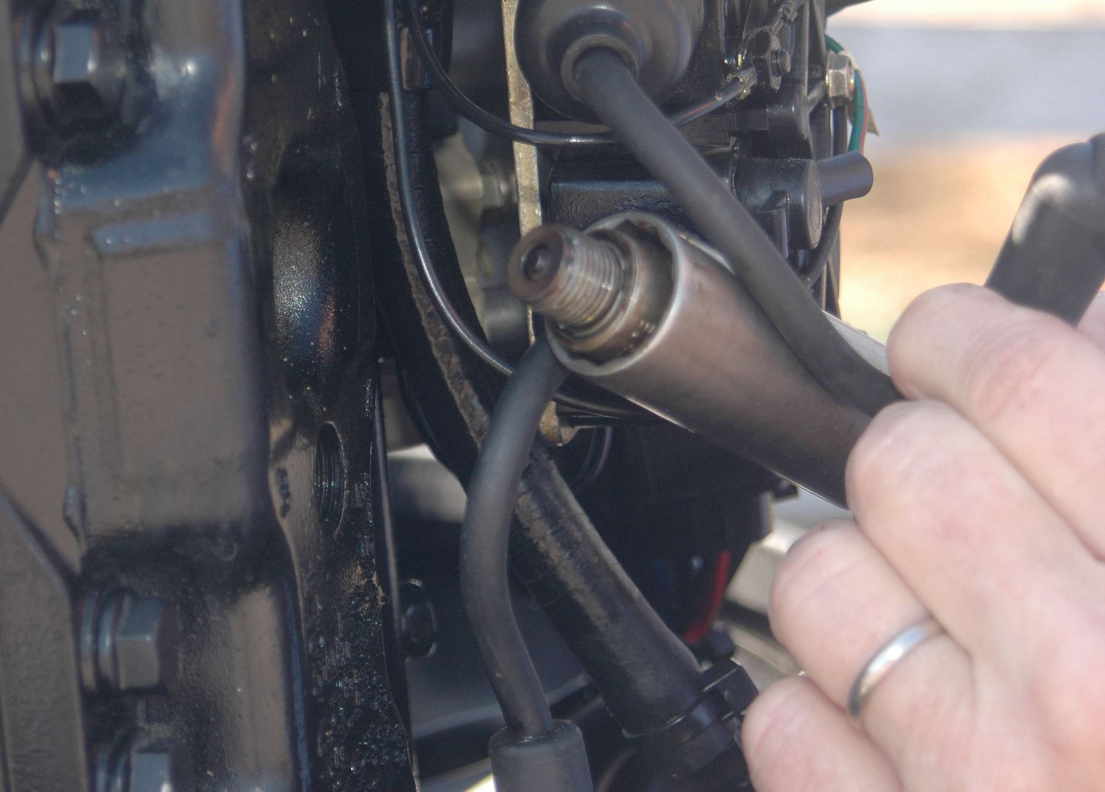 After the outboard idles for five to 10 minutes, shut it off. Remove and replace the spark plugs one at a time while doing the compression test.