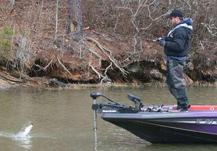 A small bass is unceremoniously skipped across the surface as McClelland reels it quickly in.