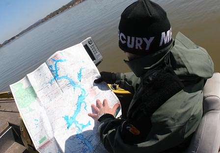 He looks at a map of Lay Lake to help decide on his next practice spot.