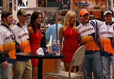 Auburn University's College Bass fishing team poses with Expo hostesses.