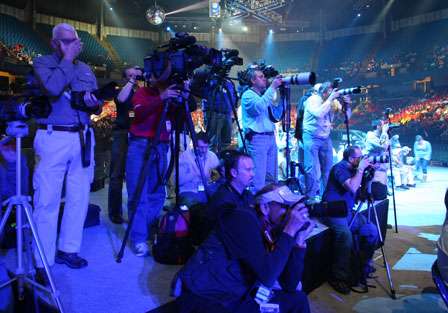 A group of photographers shoot the weigh-in.