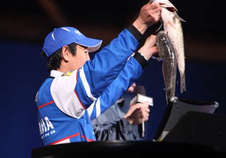 Takahiro Omori lifts his two largest bass for the crowd.
