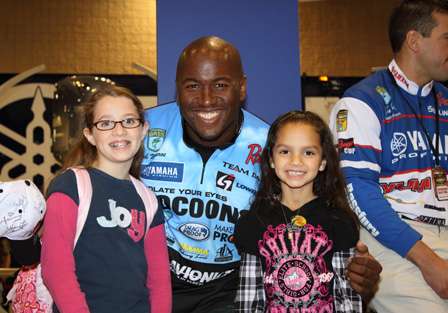 Elite Series angler Ish Monroe poses with fans during the Bassmaster Classic Expo at the Birmingham-Jefferson Civic Center.
