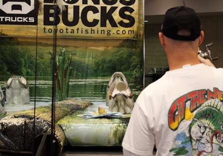 David Stokes tries his hand at a casting game at the 2010 Bassmaster Classic Expo.