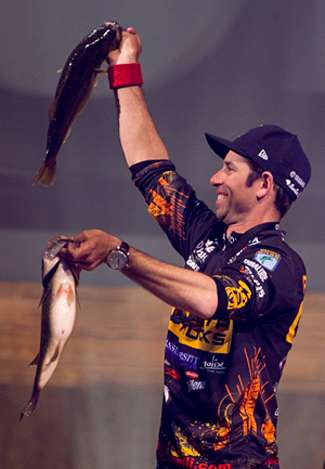 Mike Iaconelli holds up two big keeper Lay Lake bass on Day Two.