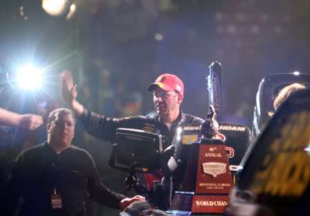 Lights flash as 2010 Bassmaster Classic champion Kevin VanDam takes his victory lap around the arena.