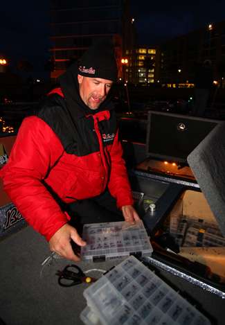 Marty Stone pulls out boxes of tackle as he rigs up some rods prior to take-off.