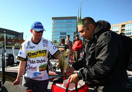 Dustin Wilks bags one of his bass while his Marshal holds his bag at the TroKar Duel in the Delta.