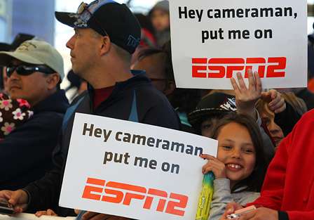 These two young fans hold up signs, trying to make it onto the airing of the Bassmaster Tournament Trail on ESPN2.