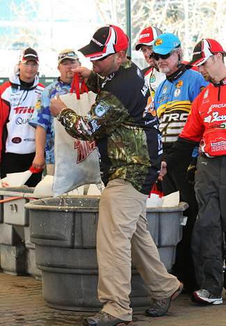 Hackney grabs his bag from the holding tanks as the rest of the anglers look on.