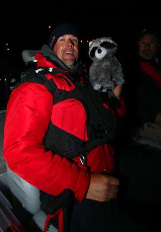 Marty Stone and his pet raccoon prepare to head out for a day of fishing on Clear Lake.