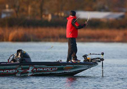 Jason Williamson slings a bait across the lake to start his morning of fishing.