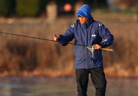 Takahiro Omori grabs a rod with a swimbait on it on Day One of the Golden State Shootout.