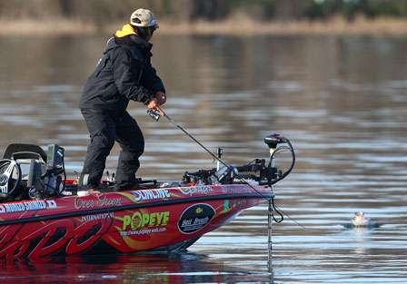 Shimizu holds his rod tip down as a good largemouth surges to the surface to make a jump.