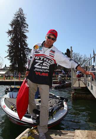 Edwin Evers takes the step from the front of his boat to the dock as he heads toward the weigh-in.