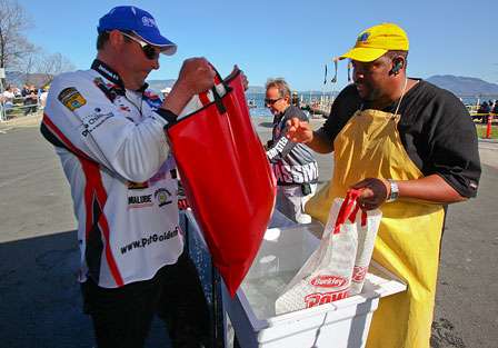 Pat Golden hefts his bag into the bump tank, where they are checked prior to weighing in.