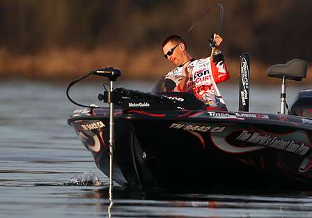 Randy Howell leans over the side of the boat to land a bass on Day Three of the Golden State Shootout.