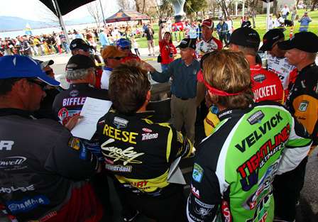 Byron Velvick, Skeet Reese and the rest of the top 12 listen as Trip Weldon gives instructions for the final day of fishing.