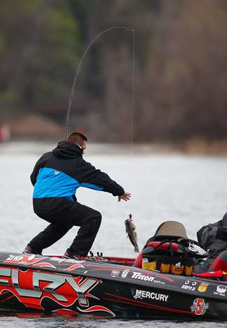 Howell swings a bass into the boat, but he had a slower morning than the previous three days.
