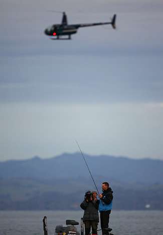 Randy Howell fishes early in the day as a helicopter flies overhead during the Golden State Shootout.