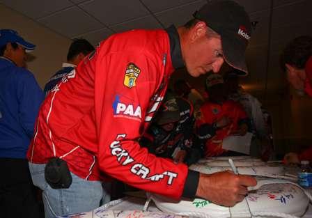 Casey Ashley and the Elite Series competitors signed BASS memorabilia before the anglers meeting. 