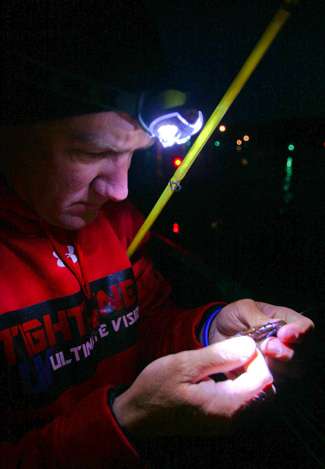 Brent Chapman uses a headlamp to make a few last-minute tackle adjustments. 