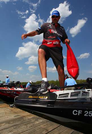 Jared Lintner steps from his boat with his Day Two sack of fish. Lintner ended the day in 38th place with 27 pounds, 3 ounces. 

