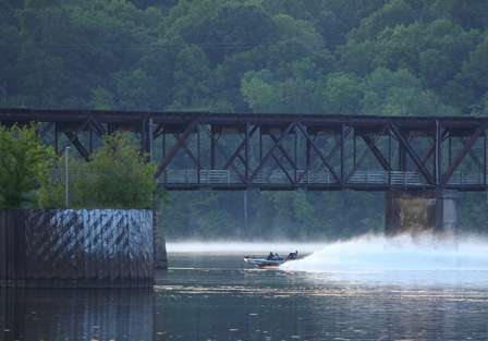 A boat speeds towards Wilson Dam on Day One. 