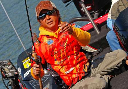 Morizo Shimizu reaches for a lure as he puts away his rods before the Day One weigh-in of the Alabama Charge.