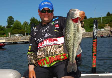 Bill Lowen holds up the biggest bass of Day One, a 7-pound Pickwick Lake largemouth.