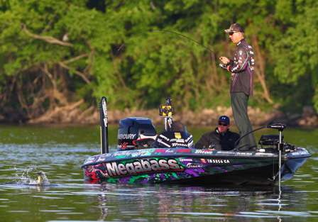 A bass takes a dive downward as Aaron Martens brings it to the boat. 