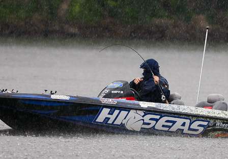 Cliff Pace takes a seat as he attempts to land a good smallmouth in a driving rain. 