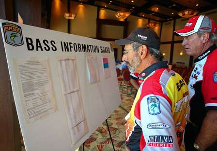 Paul Elias and Guy Eaker check out the latest announcements and standings on the BASS Information Board. 