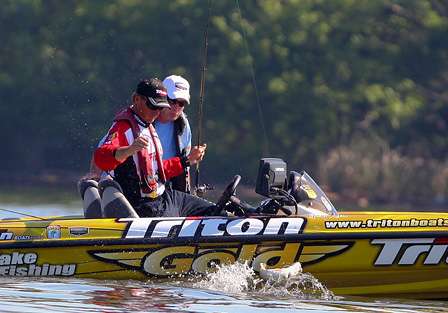 Gary Klein fights another keeper fish beside the boat while his Marshal gets a close look at the action. 