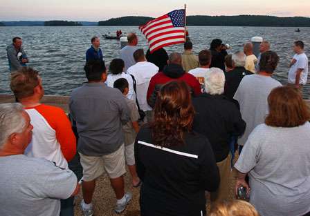 The colors fly as spectators and anglers pause for the national anthem just before the launch begins.