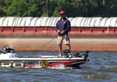 Edwin Evers fishes near some of the barges tied up along the Tennessee River that runs through Guntersville. 
