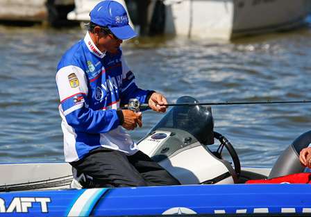 Takahiro Omori wraps up his rods after  a long day of fighting the wind on Lake Guntersville.