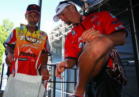 Paul Elias and John Crews compare their respective limits and wait backstage to see if they would have enough to fish Sunday.