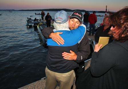 John Crews hugs his father, Bill, who wishes him luck on the final day.