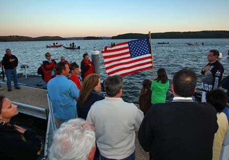 The flurry of activity around the dock comes to a stand-still during the playing of the national anthem.